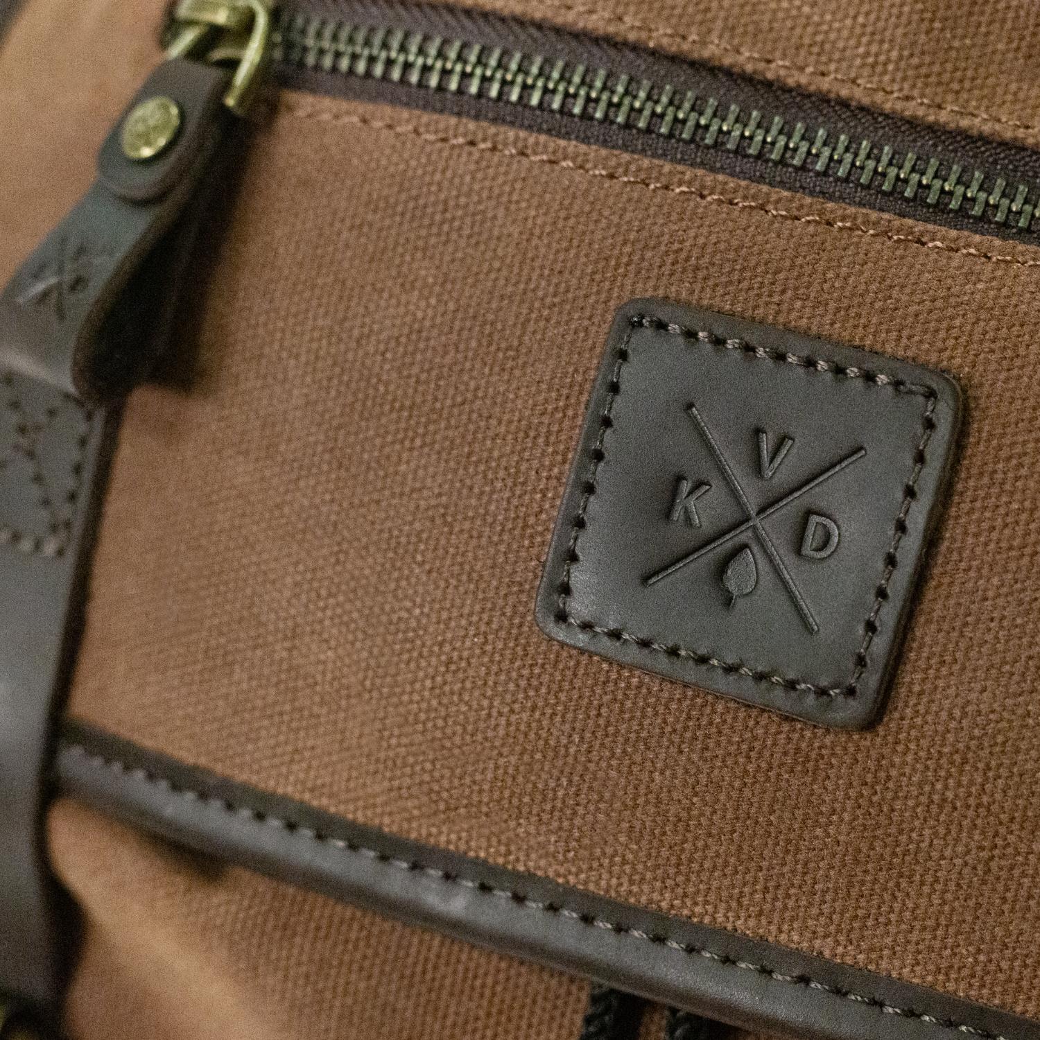 Close up image of the water resistant canvas and dark leather on the Lune backpack