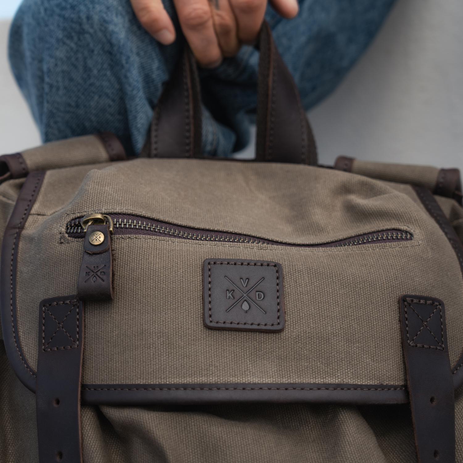Close up image of canvas and leather on the Lune - Moss Green Backpack