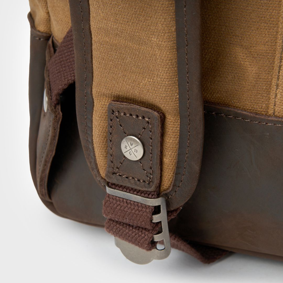 Eden waxed canvas backpack straps with Kovered logo on rivets