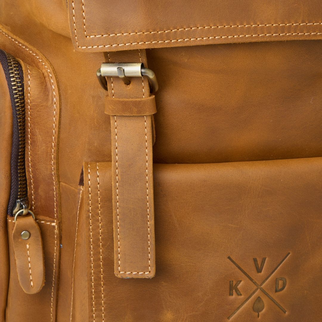 Close up of magnetic buckle on reclaimed leather Esk backpack