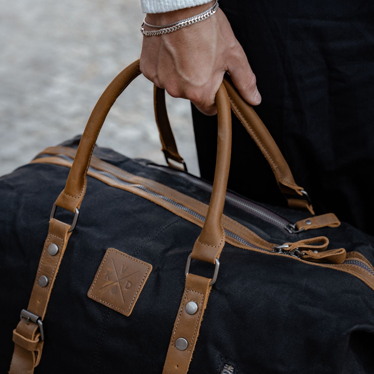 Close up image of the reclaimed leather and waxed canvas on the Humber duffel bag.
