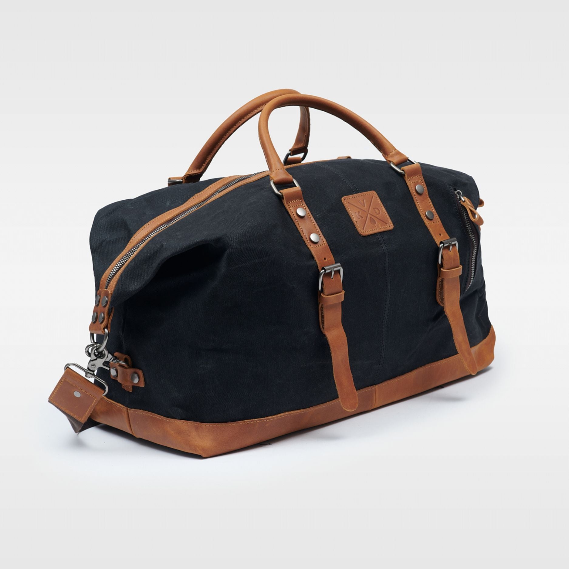 Kovered Humber holdall black and tan duffle made from waxed canvas and reclaimed leather angled view#colour_black