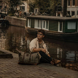 Kovered moss green Humber holdall in Amsterdam next to a canal#colour_moss-green