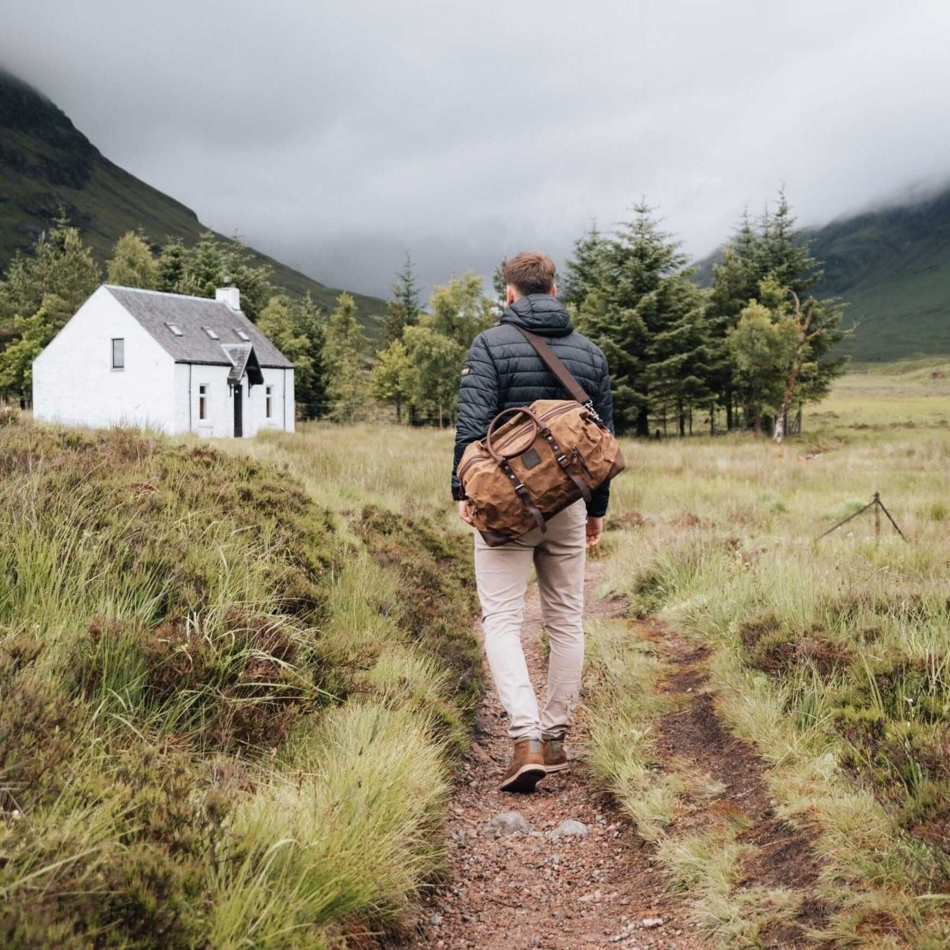 Kovered tan Humber holdall being carried by a man walking through a field#colour_tan