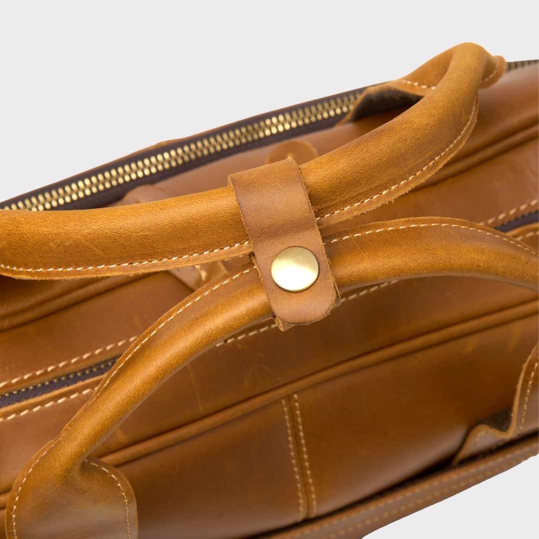 Close up of the leather handles on the Manifold laptop bag