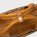 Close up of the leather handles on the Manifold laptop bag