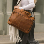 Women walking carrying the Manifold leather laptop bag
