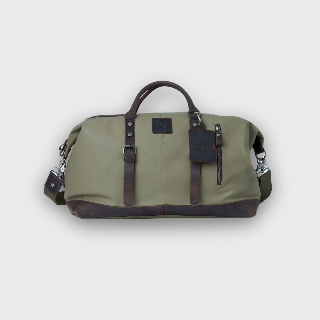 Green duffel bag with brown leather accents on a light gray background