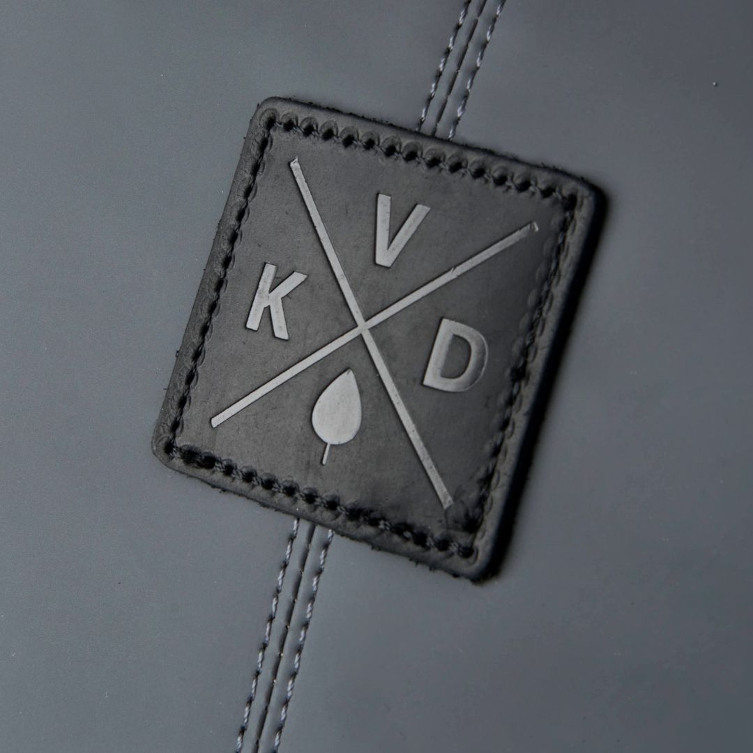 Square leather patch with 'KVD' logo on a gray background