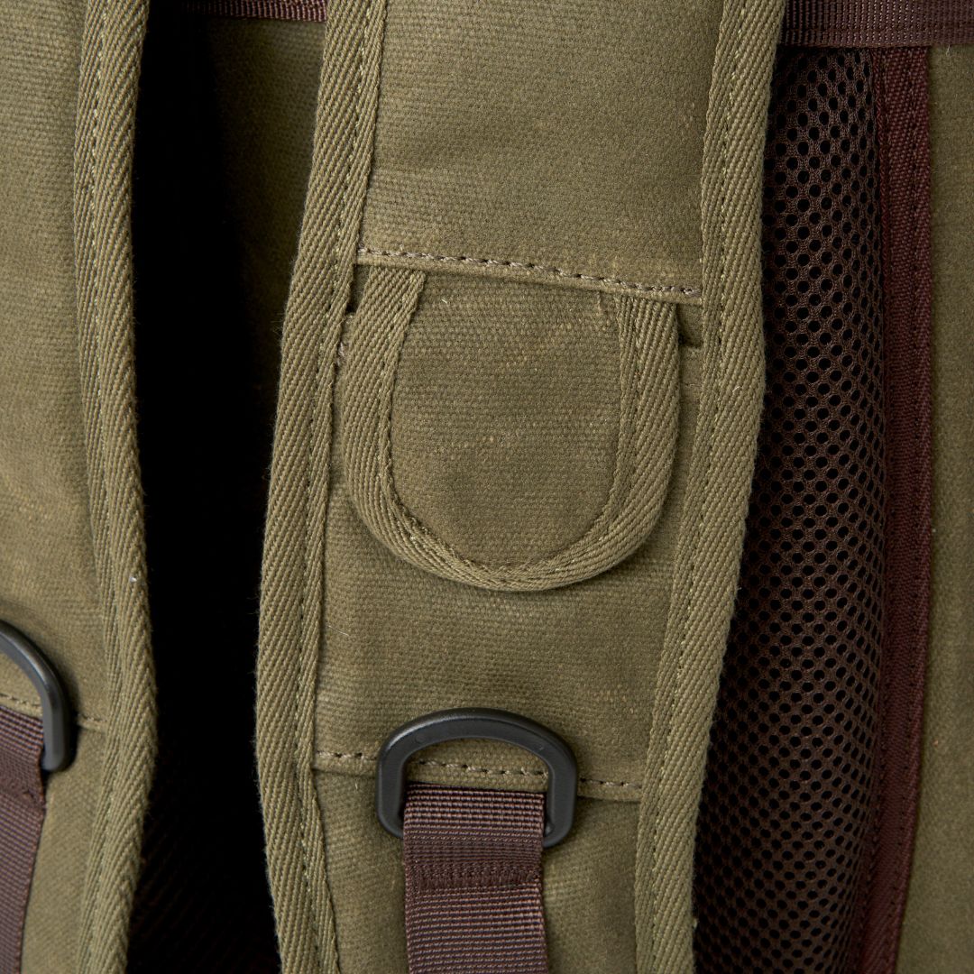 Close up image of waxed canvas on the Moss Green Roe camera/adventure backpack.