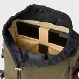 Padded laptop pocket with elasticated fastener inside the waxed canvas Roe backpack.