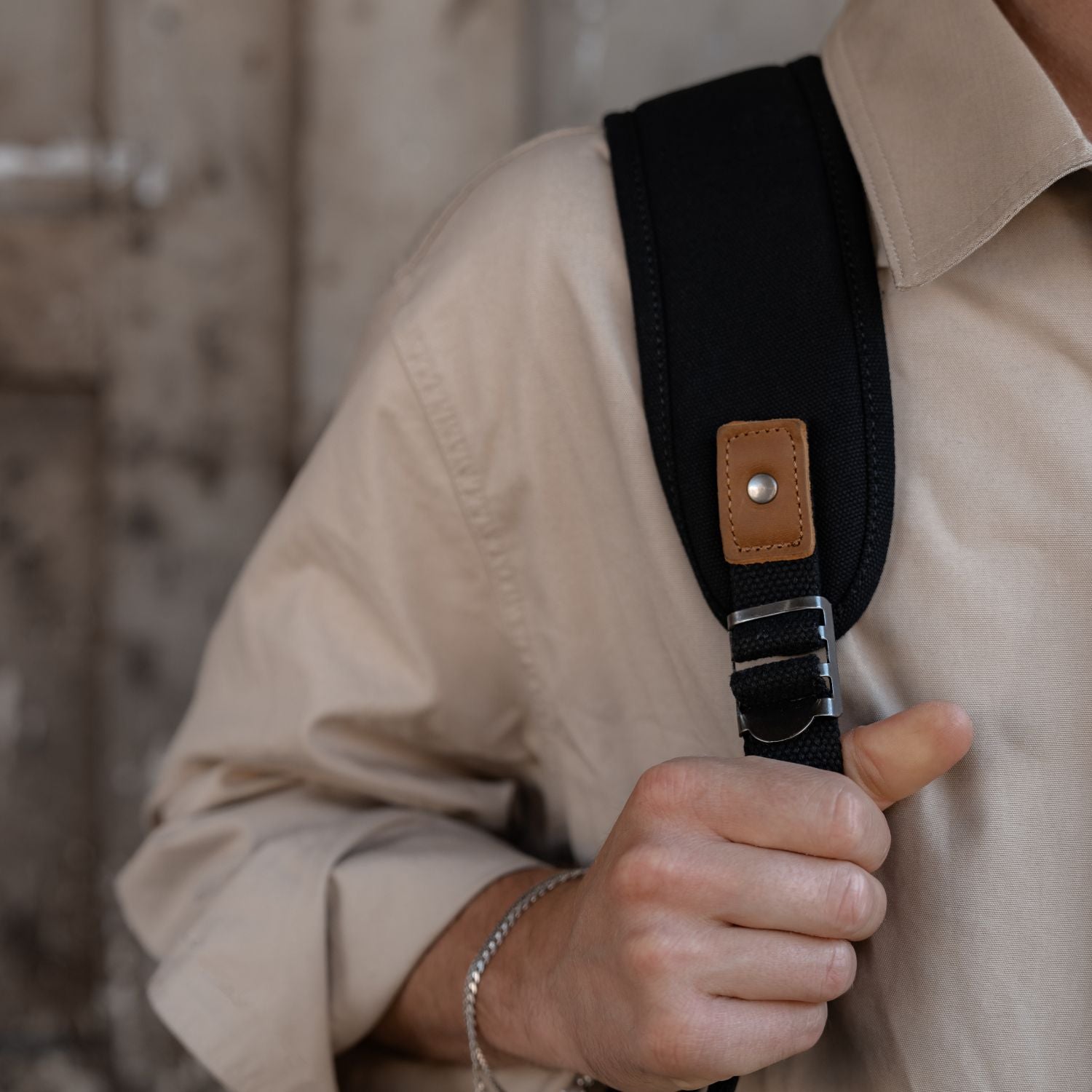 Padded backpack strap on the Tay rolltop black canvas backpack