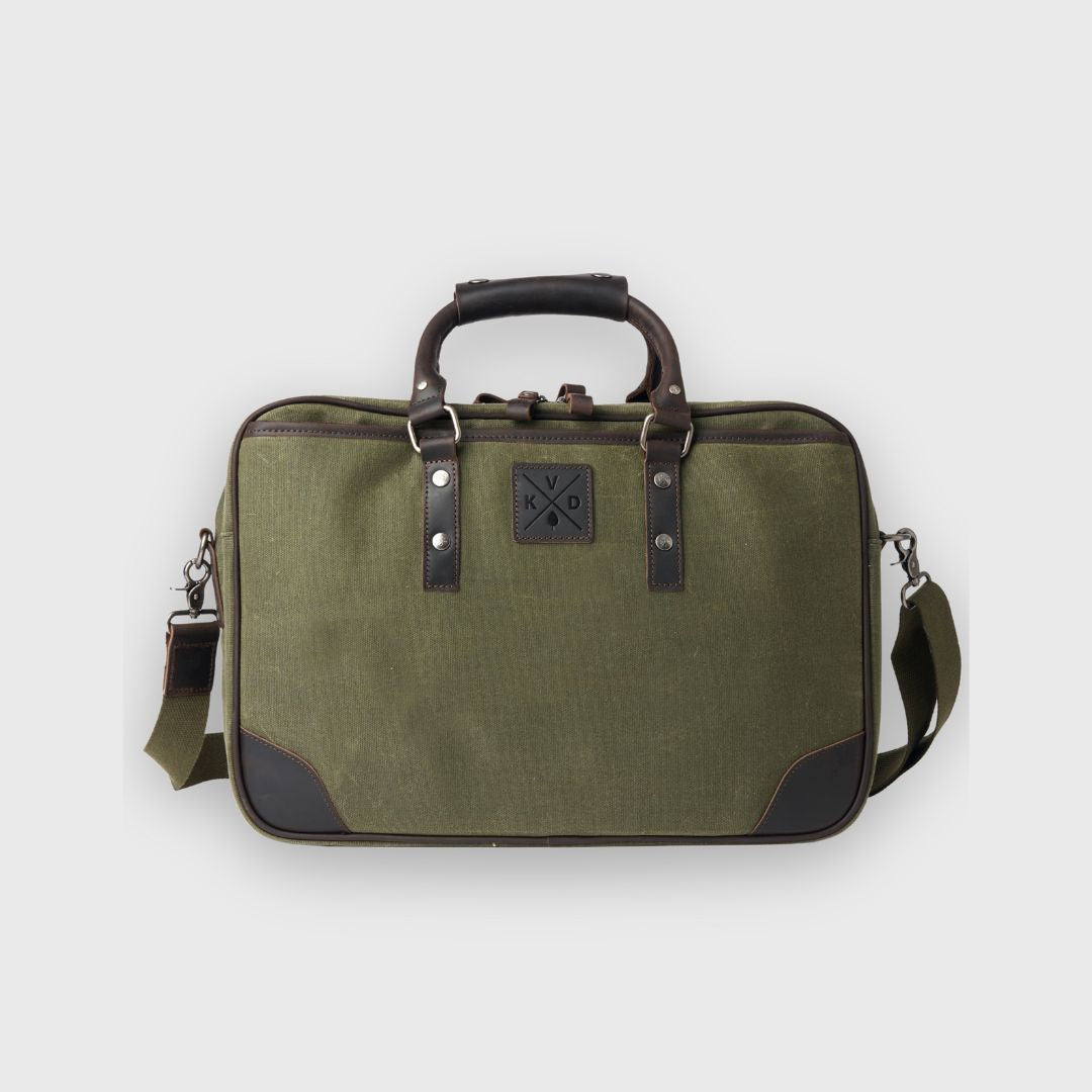 Green travel bag with black accents on a light gray background