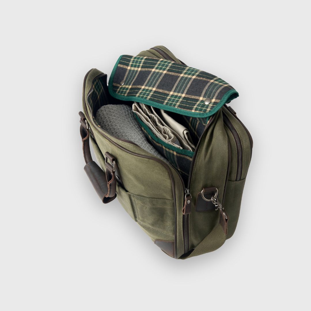 Green leather bag with plaid lining on a light gray background