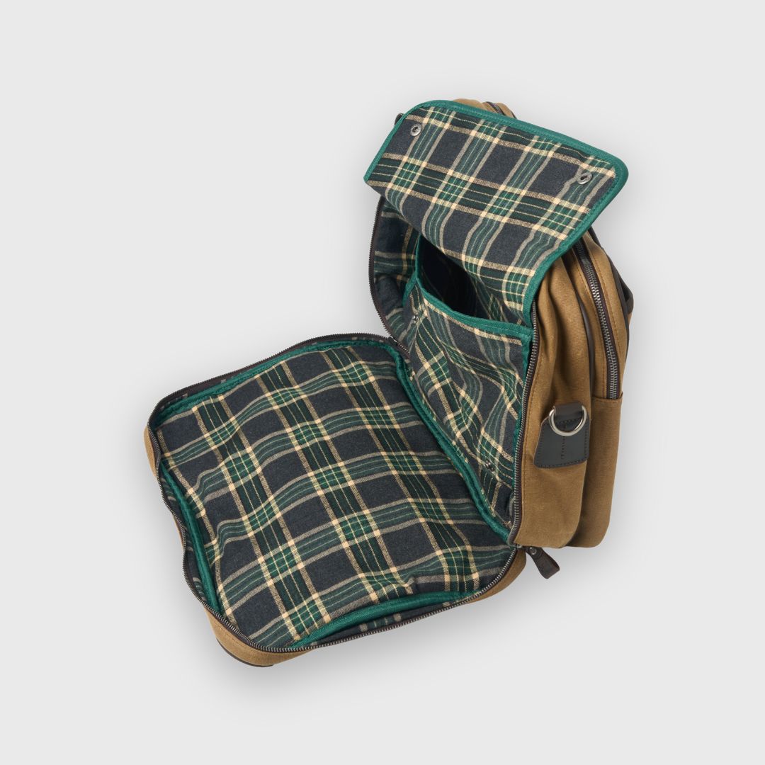 Plaid-patterned bag with brown leather accents on a white background