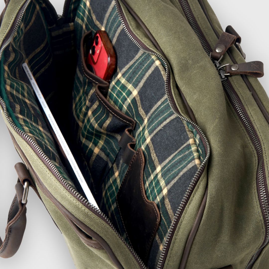 Green plaid bag with a red item inside on a white background