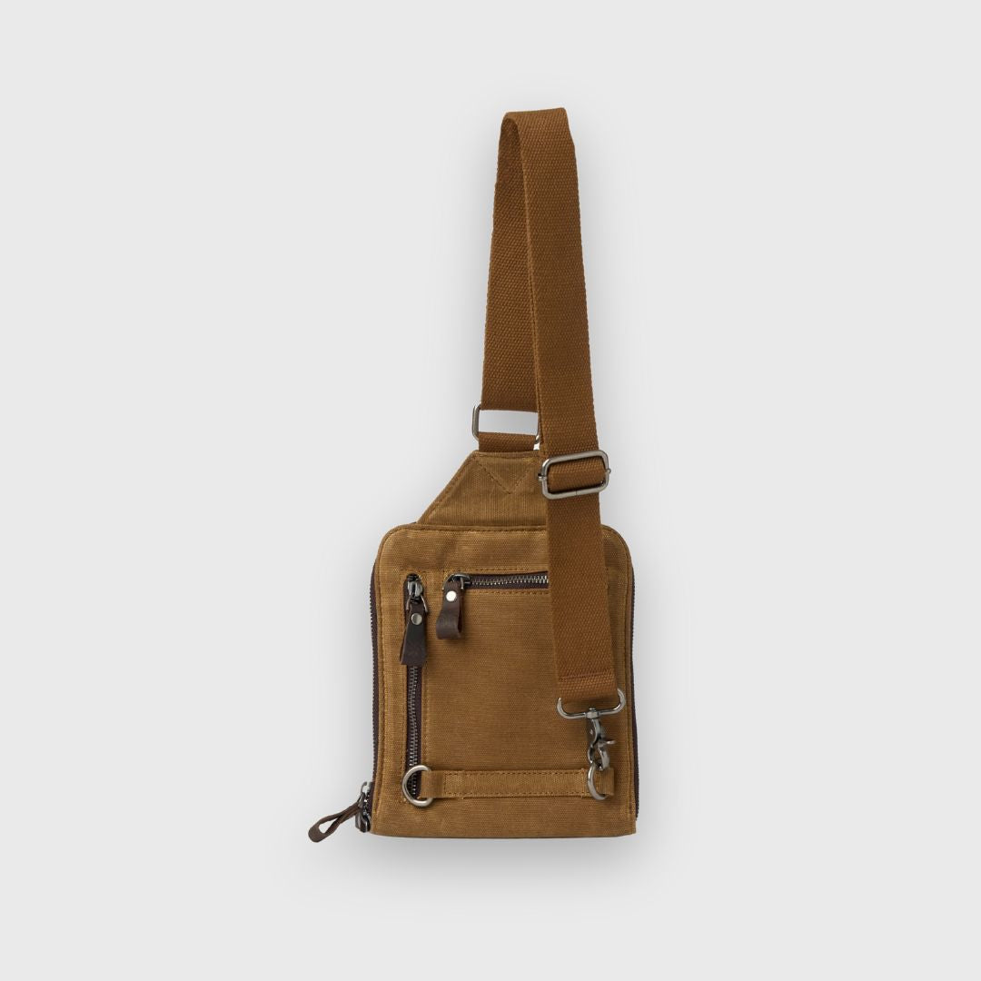 Brown leather sling bag on a light gray background