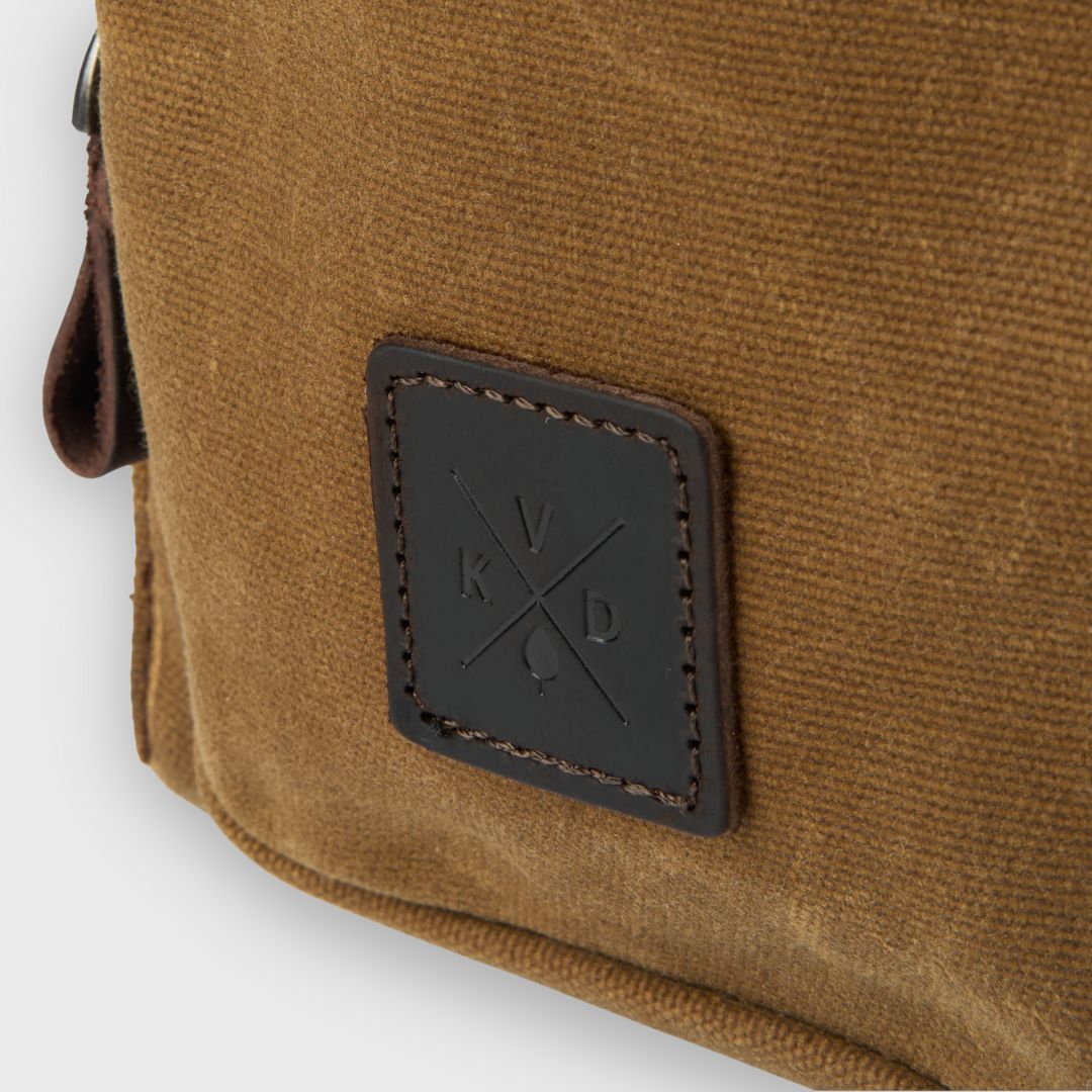 Brown leather bag with a brand logo on a white background