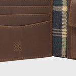 Close up image of the reclaimed leather and polyester tartan lining inside the Ashford wallet.