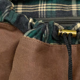 Drawstring closure and brass toggle on the Lune Backpack.