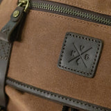 Close up image of the water resistant canvas and dark leather on the Lune backpack