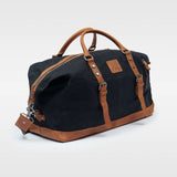 Kovered Humber holdall black and tan duffle made from waxed canvas and reclaimed leather angled view#colour_black