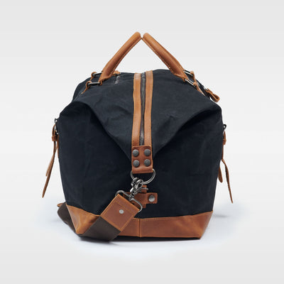 Kovered black and tan Humber duffle bag side view made from waxed canvas and reclaimed leather#colour_black