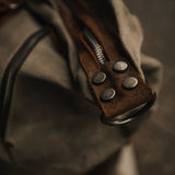 Kovered waxed canvas and reclaimed leather moss green duffel bag close up of detail#colour_moss-green