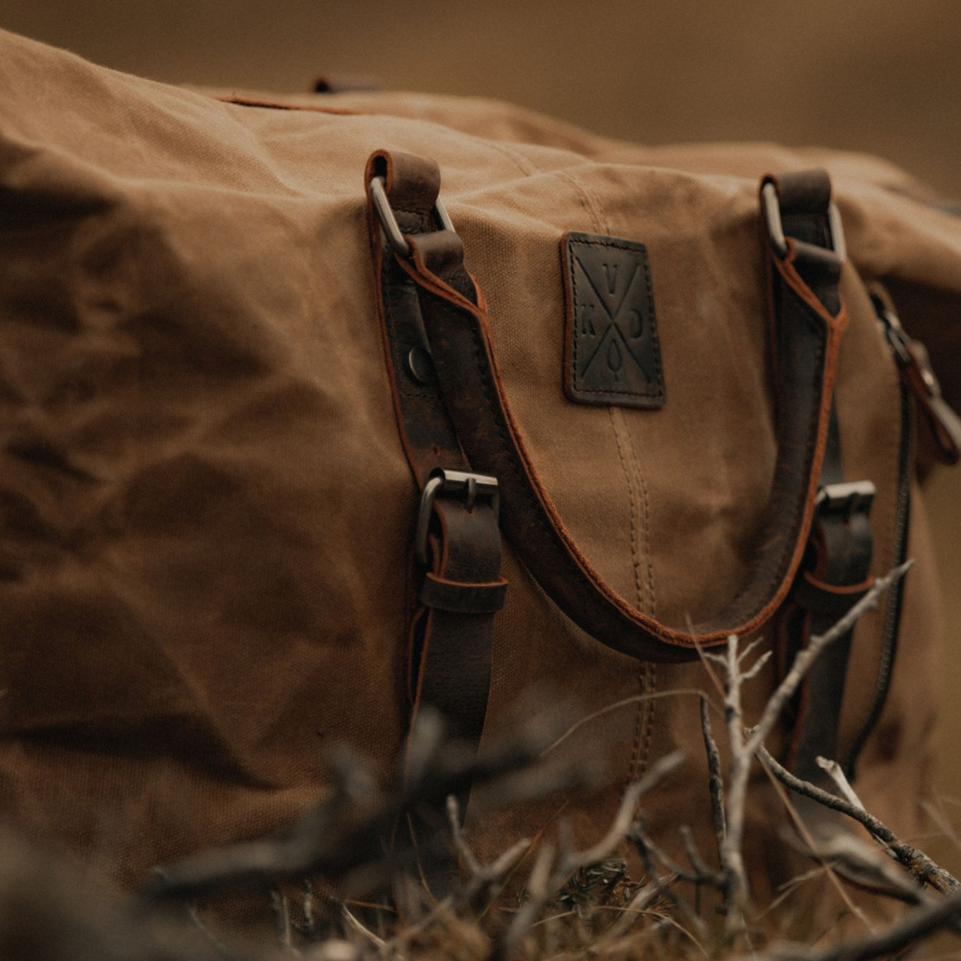 Kovered Humber holdall in tan close up of the logo detail#colour_tan