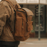 Side image showing zipped pockets on the side of the Esk leather backpack