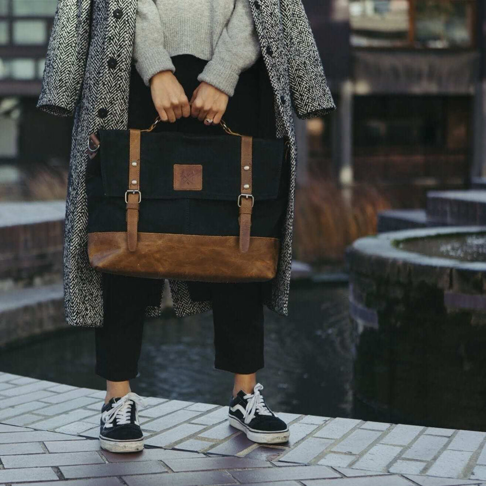 Mersey Waxed Canvas Messenger Bag Black and Tan held by model#colour_black