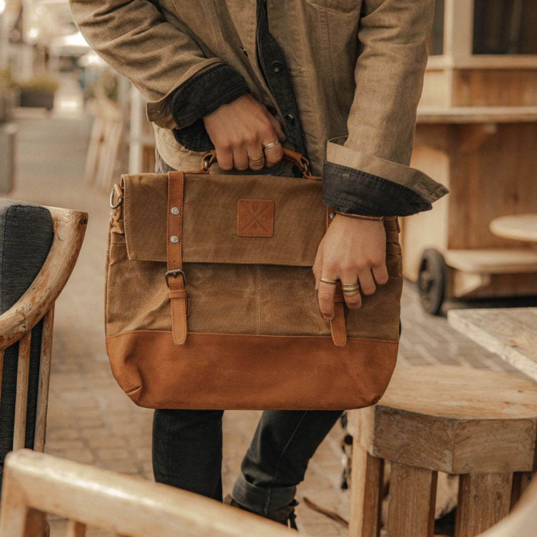 Kovered Mersey satchel messenger bag in brown being held by model#colour_tan