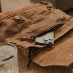 Kovered Mersey brown messenger bag with apple iPhone coming out of the pocket#colour_tan