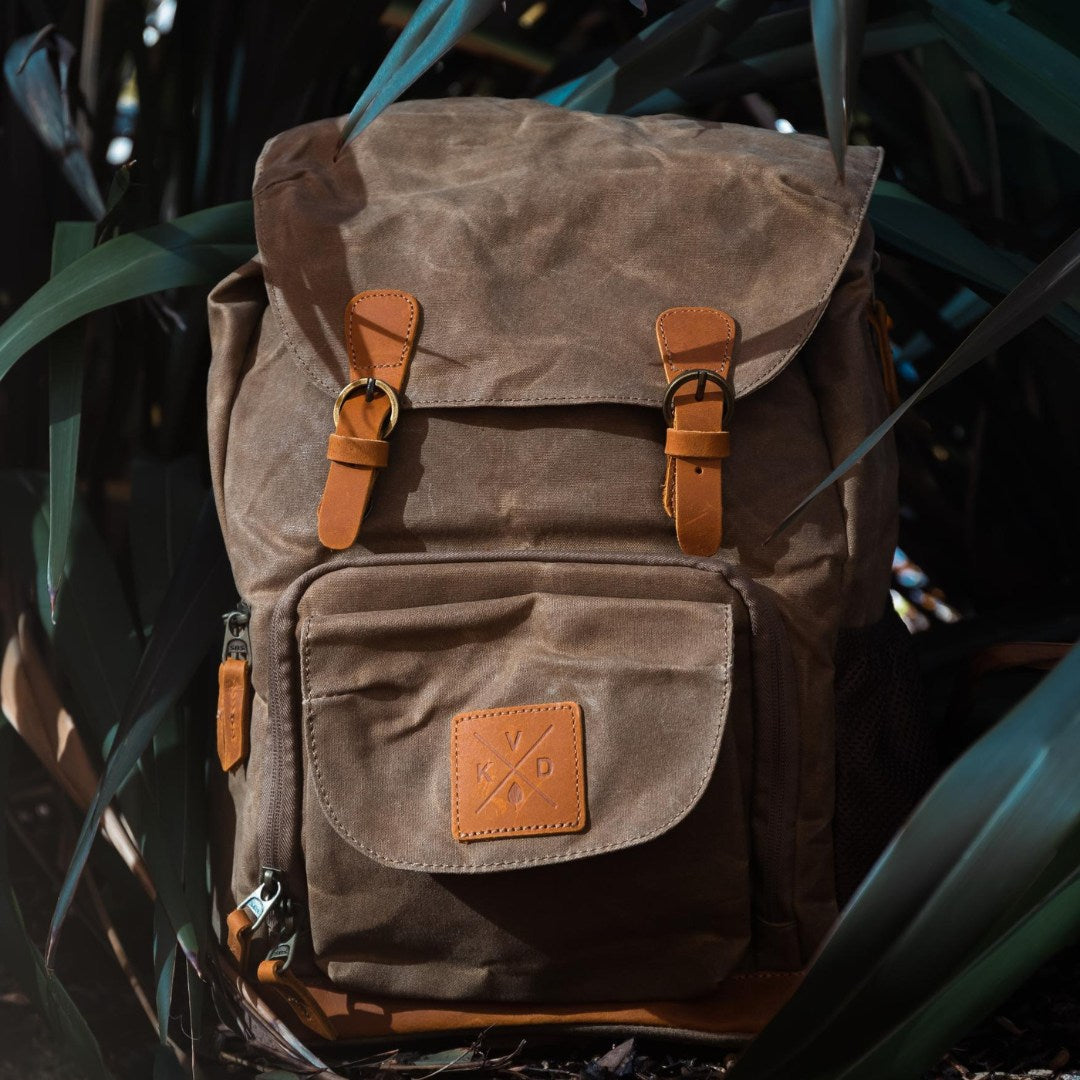 Kovered Roe adventure backpack in moss green lifestyle shot of the backpack outdoors in a bush#colour_moss-green