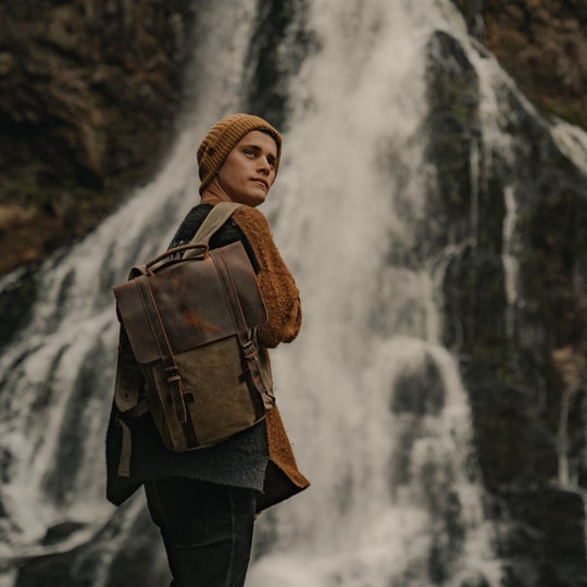 Kovered Tamar moss green reclaimed leather backpack in front of waterfall#colour_moss-green