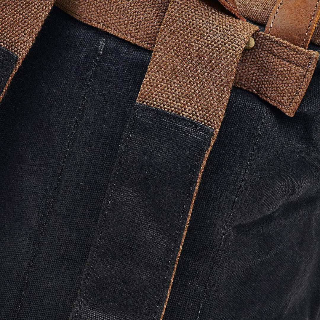 Kovered Taw waxed canvas rolltop backpack black and tan close up of the backpack straps#colour_black
