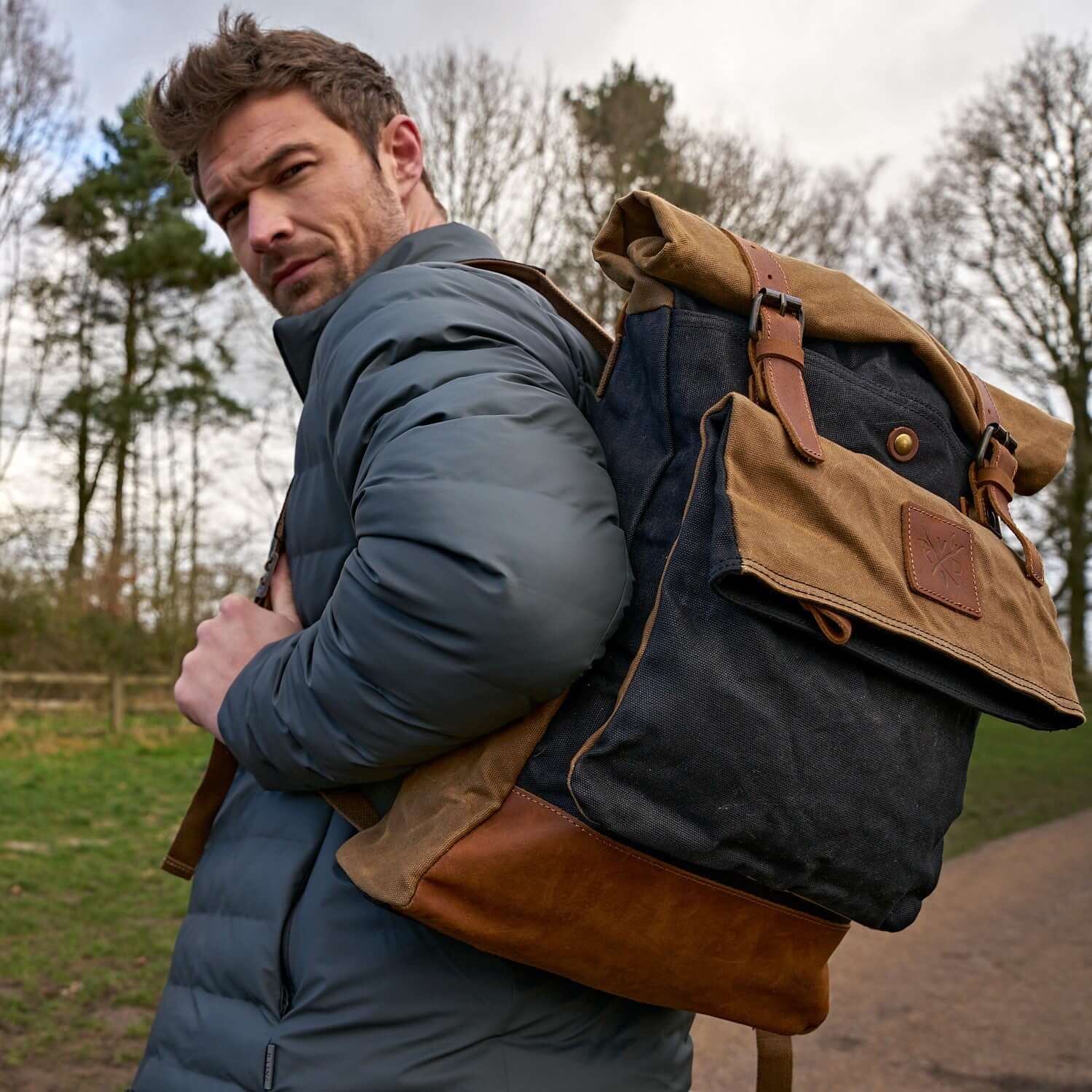 Kovered Taw waxed canvas rolltopback black and tan on a model#colour_black