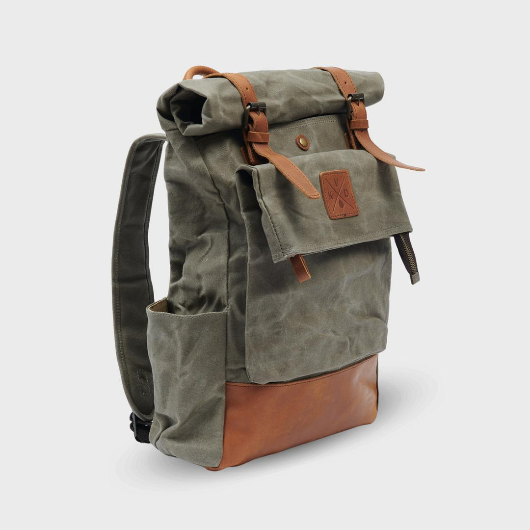 Green waxed canvas rolltop backpack angled view#colour_moss-green