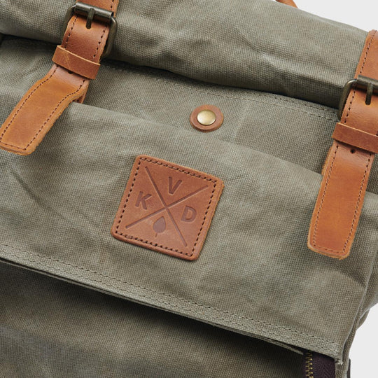 Green waxed canvas rolltop backpack close up of detail and Kovered logo#colour_moss-green