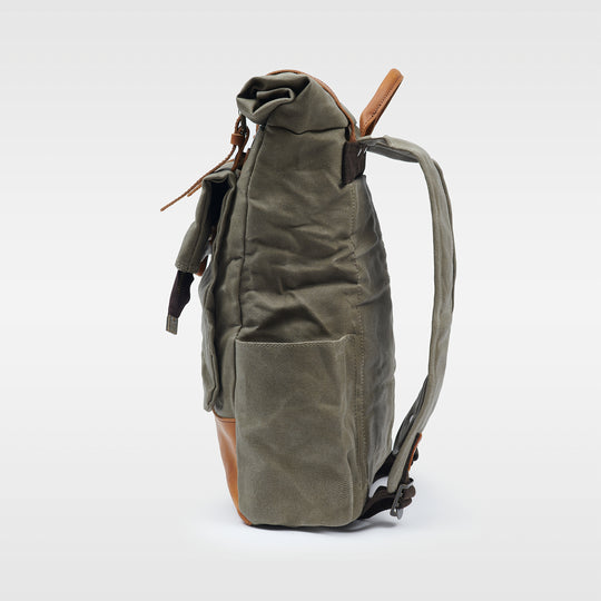 Green waxed canvas rolltop backpack side view#colour_moss-green
