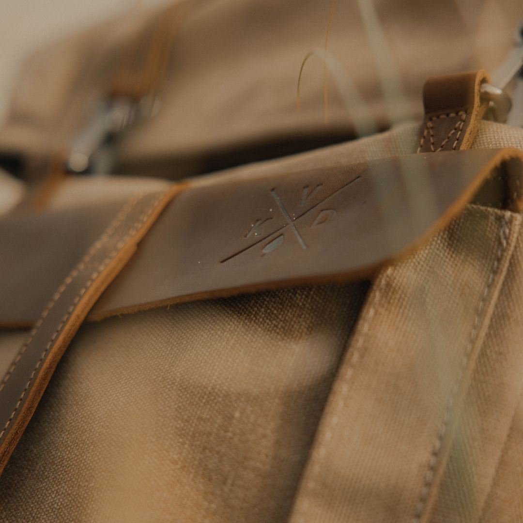 Kovered Tay tan canvas backpack close up of KVD logo#colour_tan