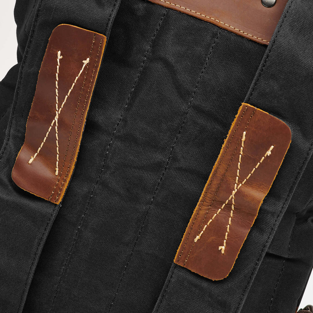 Kovered Thames waxed canvas and reclaimed leather backpack black close up of backpack straps#colour_black
