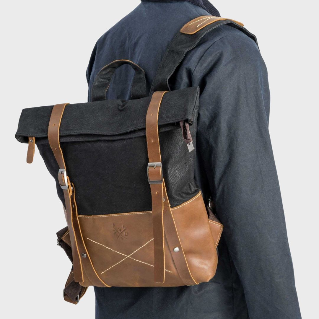 Kovered waxed canvas and reclaimed leather water resistant black backpack on male model#colour_black