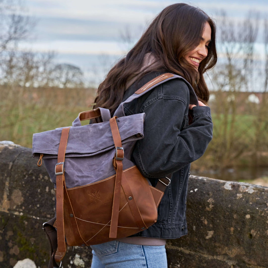 Thames waxed canvas and reclaimed leather backpack on female model#colour_grey