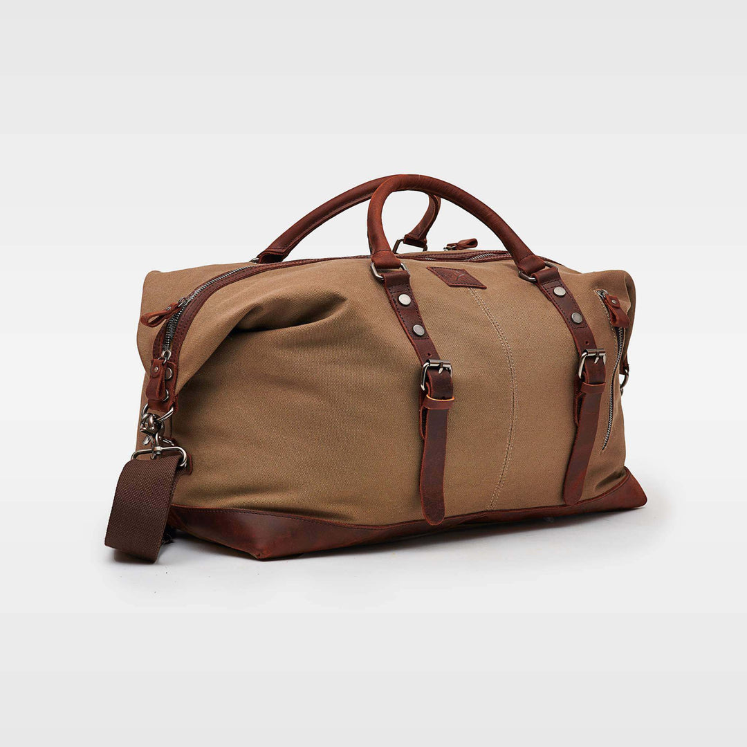 Brown Torridge sustainable duffle bag angled view with shoulder strap#colour_brown