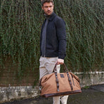 Torridge brown holdall being carried by model walking down the street#colour_brown