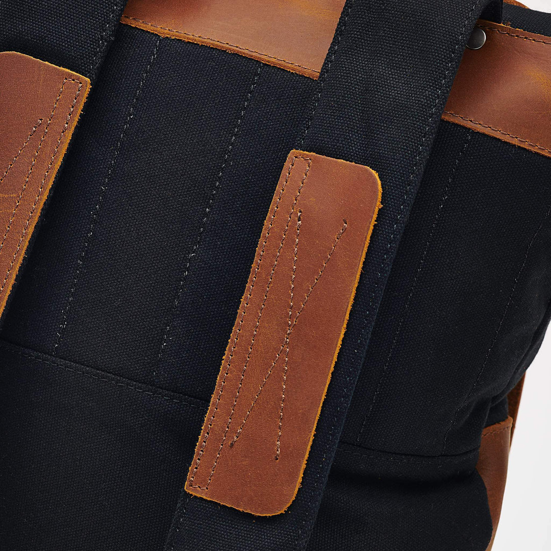 Witham black and tan reclaimed leather backpack close up detail of backpacks straps#colour_black