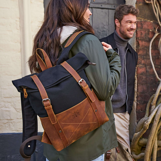 Kovered Witham black and tan backpack on a female model in a green coat#colour_black