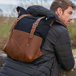 Kovered Witham black backpack on male model wearing a black coat#colour_black