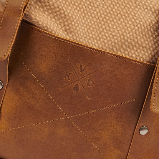 Witham tan backpack close up of KVD logo printed into leather patch#colour_tan